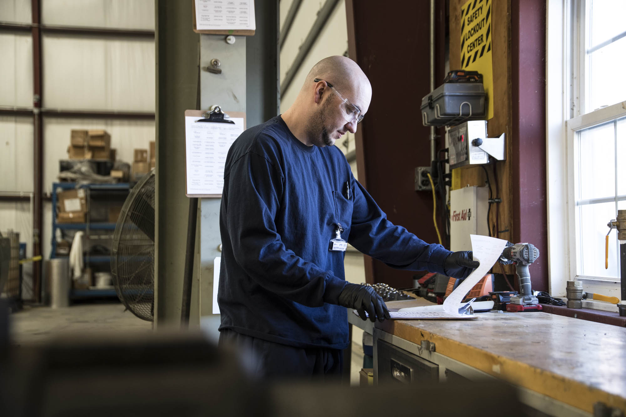 Technician reviewing inspection documentation in the fabrication shop