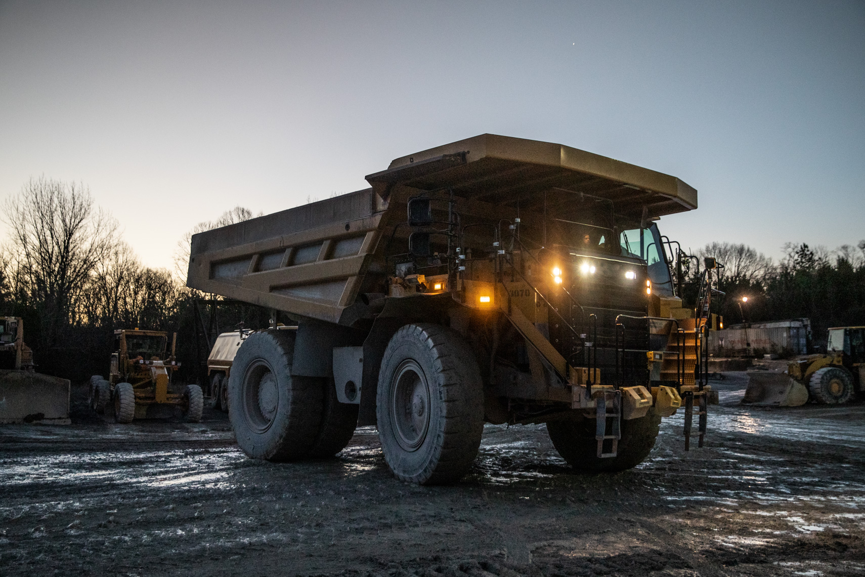 Mining haul truck at dusk on an active mine site