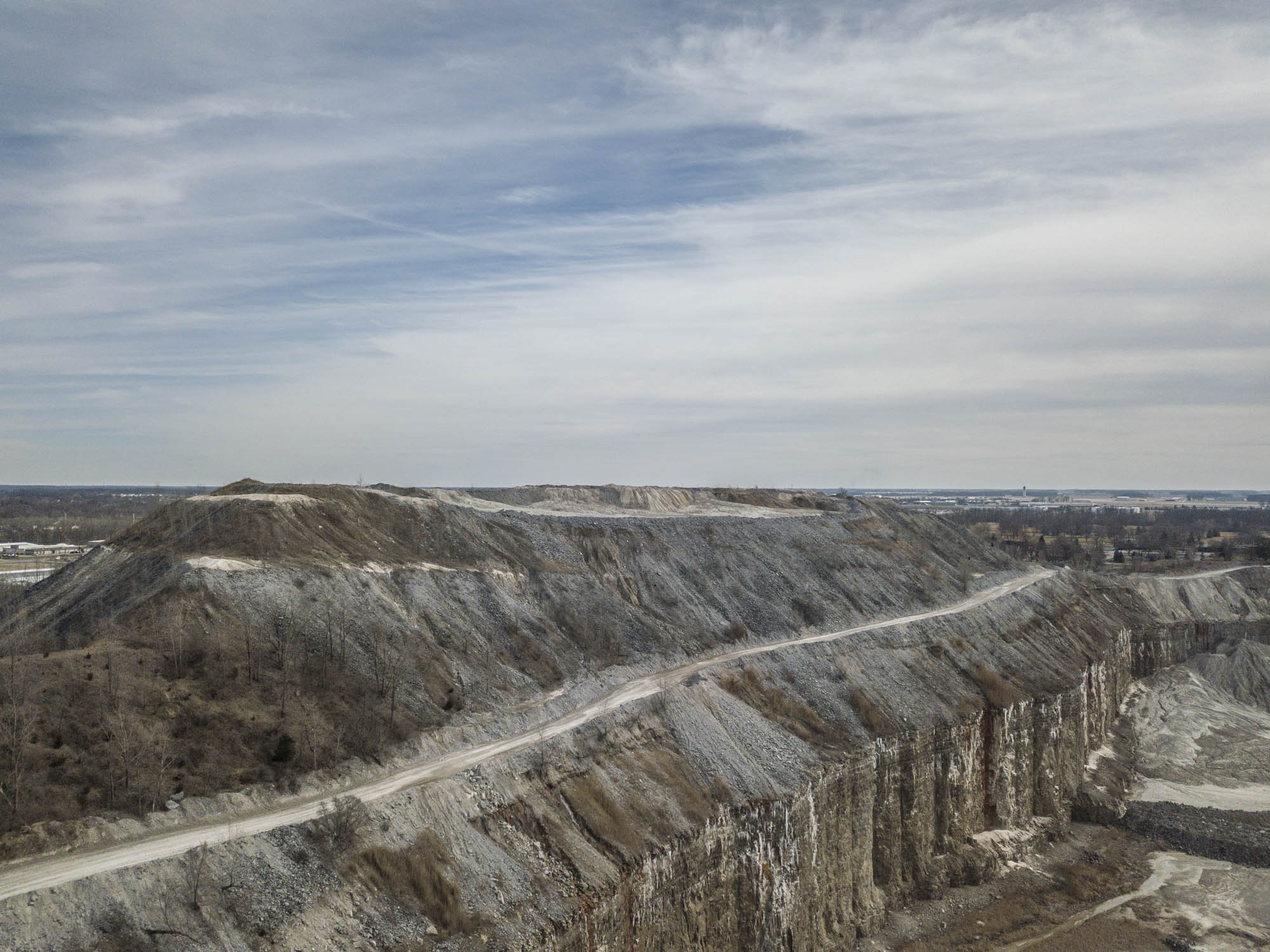 Aerial view of quarry benches and a haul road cut into stone