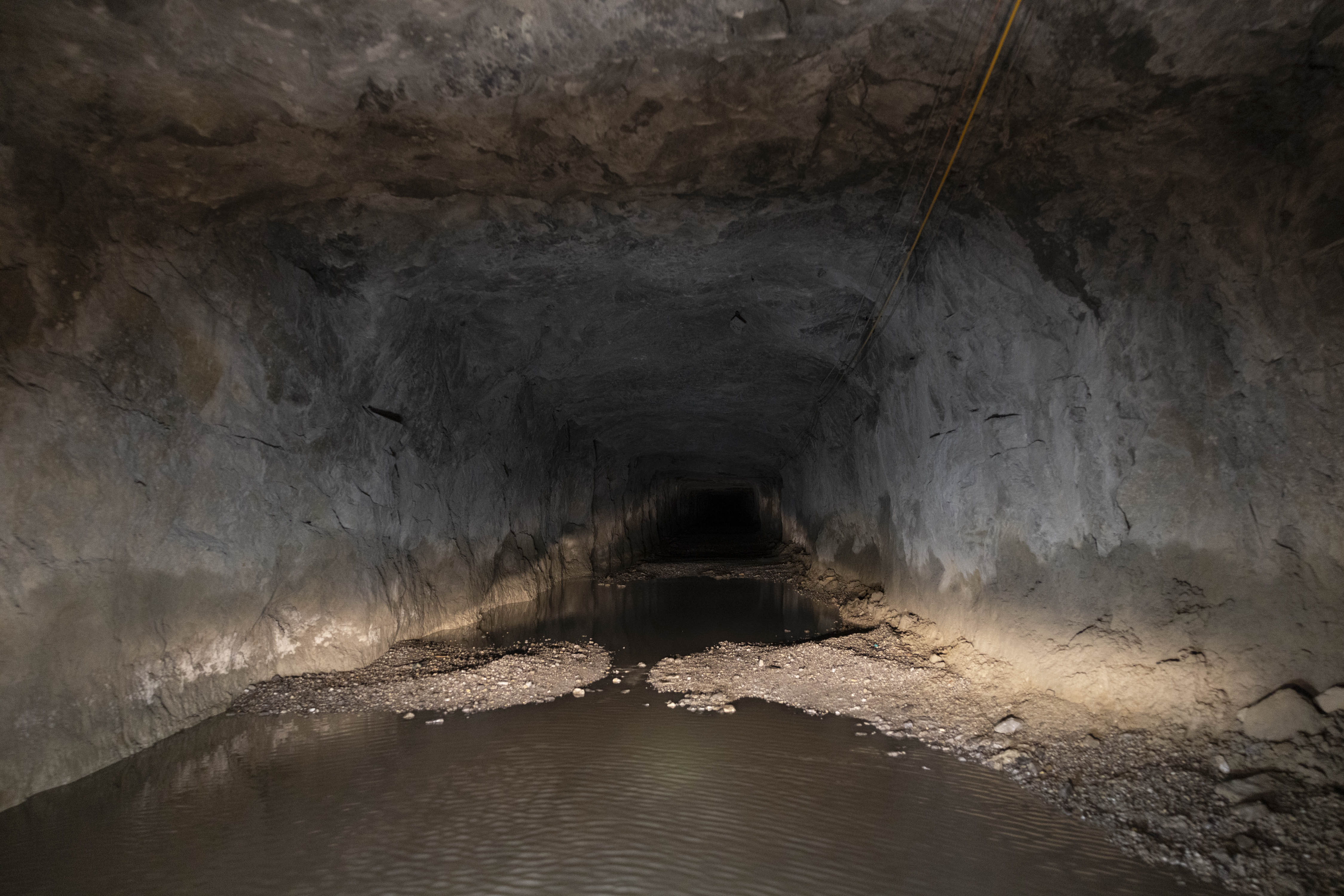 Underground mine tunnel approach with standing water