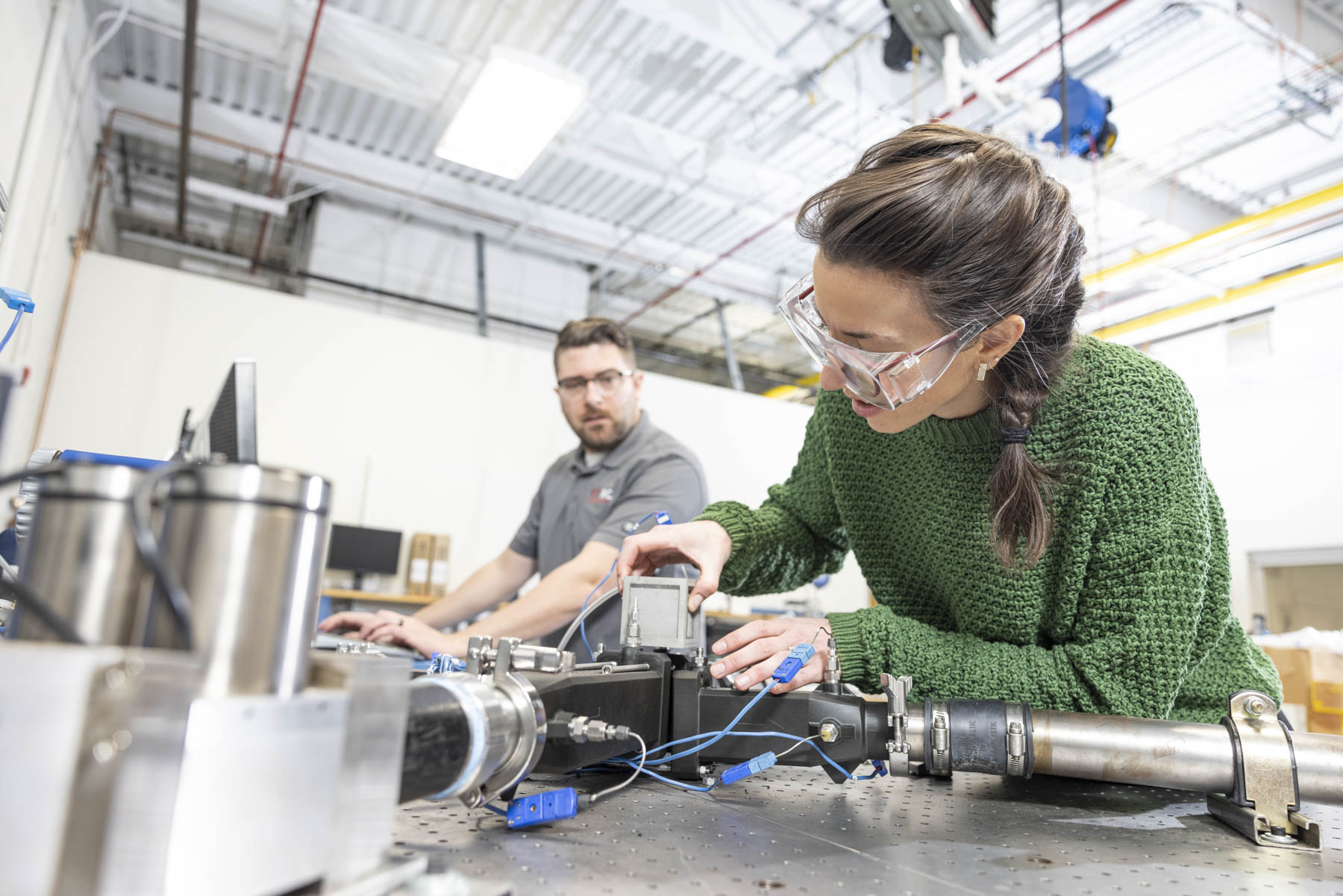 Engineer conducting precision testing inside an aerospace and defense manufacturing facility