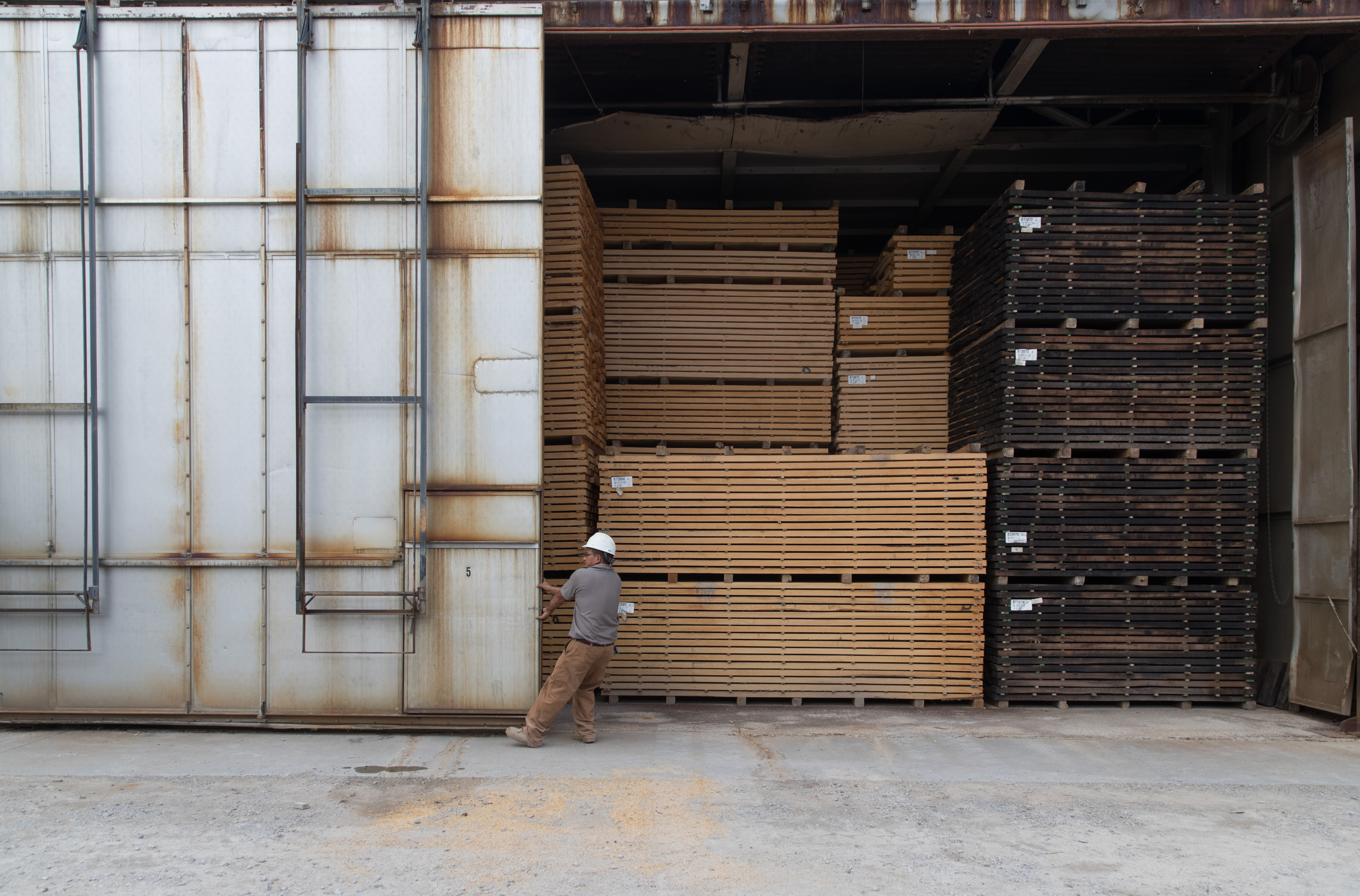 Timber yard worker directing material handling for a recruiting campaign
